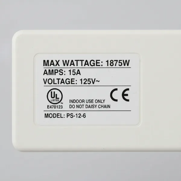 Technical specifications labels on a power strip, including wattage, amperage, and safety certifications.